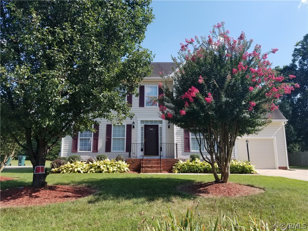 1224 Tree Ridge Road Henrico, VA 23231 - Photo 2 of 20 a front view of a house with a yard and potted plants