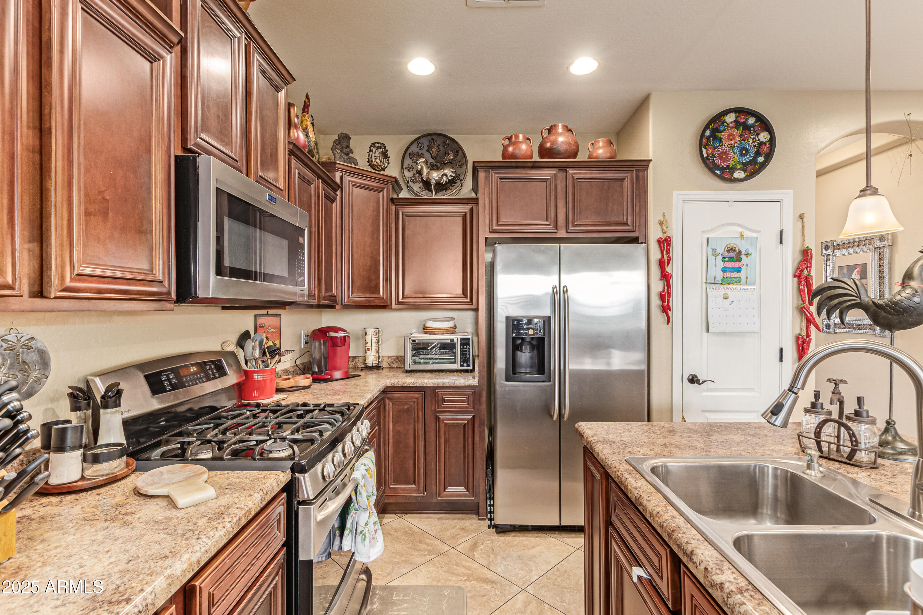3238 East Ridgewood Lane Gilbert, AZ 85298 - Photo 11 of 43 a kitchen with stainless steel appliances granite countertop a refrigerator and a sink