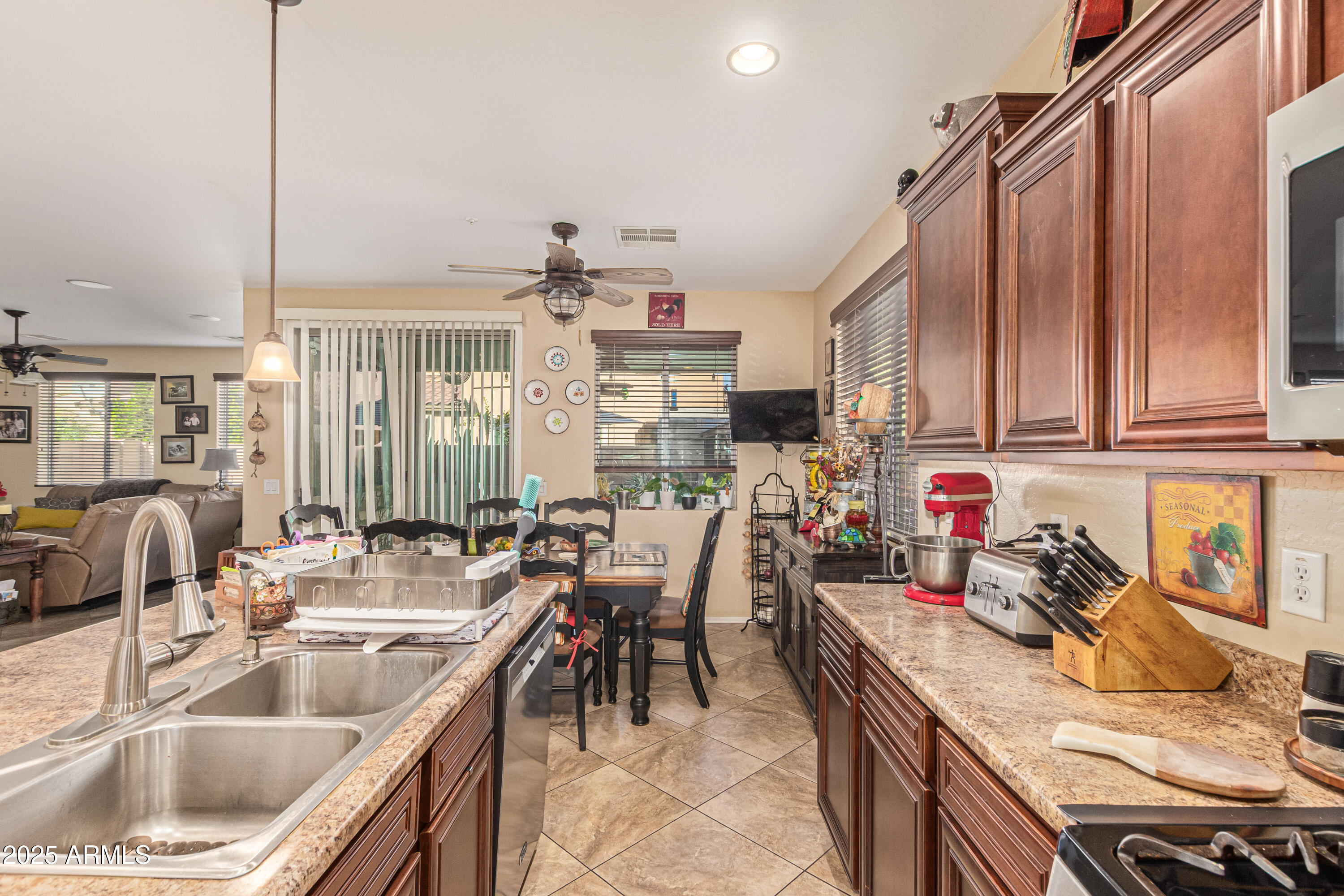 3238 East Ridgewood Lane Gilbert, AZ 85298 - Photo 12 of 43 a kitchen with stainless steel appliances kitchen island granite countertop a sink and cabinets