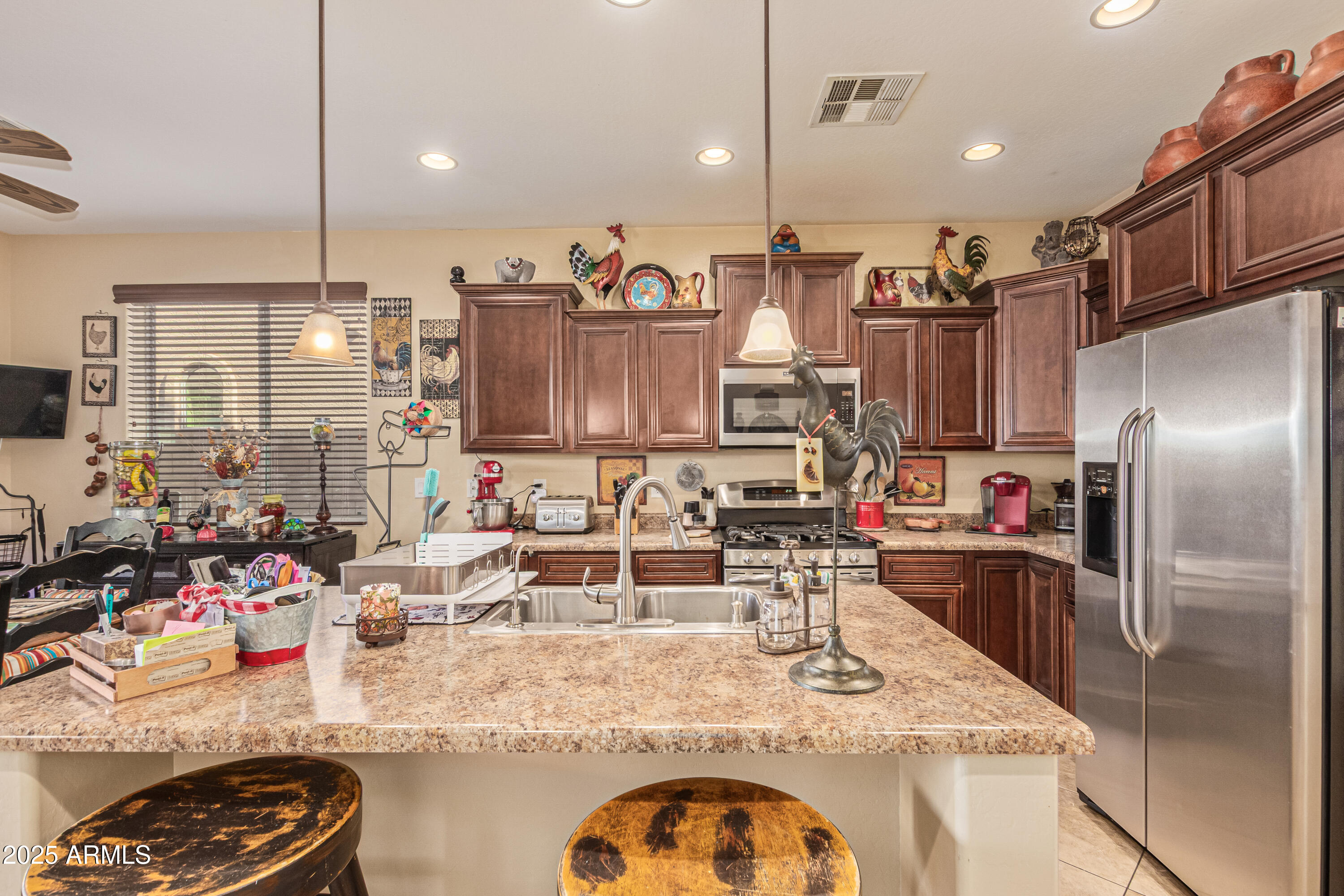 3238 East Ridgewood Lane Gilbert, AZ 85298 - Photo 10 of 43 a kitchen with kitchen island granite countertop a sink appliances and cabinets