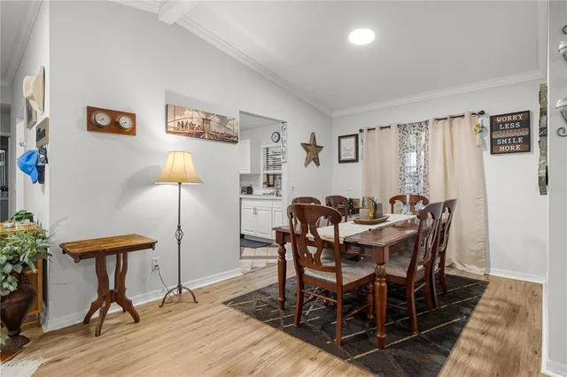 a view of a dining room with furniture and a window