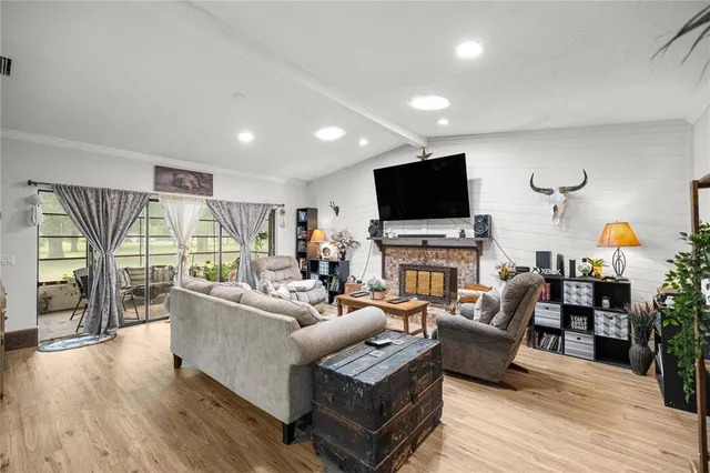 a living room with fireplace furniture and a flat screen tv