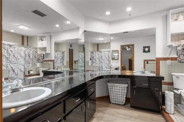 a large kitchen with stainless steel appliances granite countertop a sink and a counter space