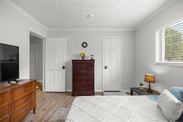 a bedroom with a bed and a television