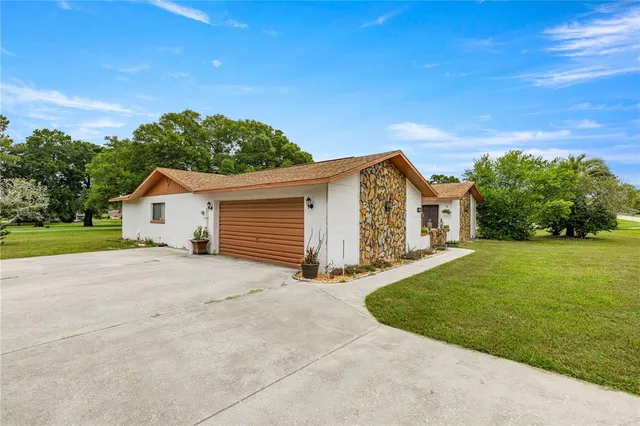 a view of a house with a yard and garage