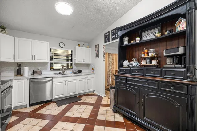 a kitchen with stainless steel appliances granite countertop a stove and cabinets