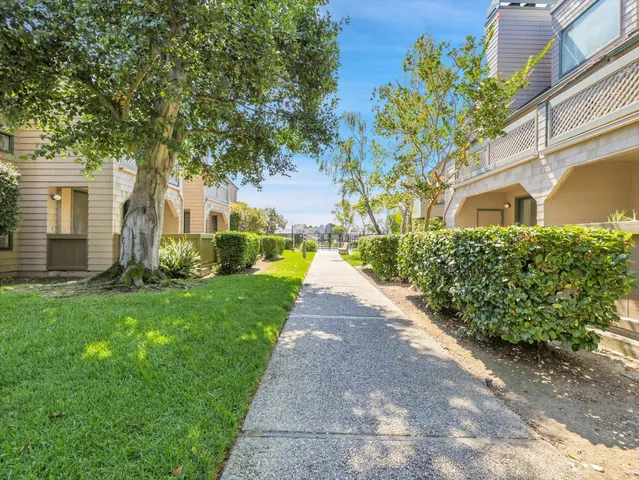 a front view of a house with a yard and a garden