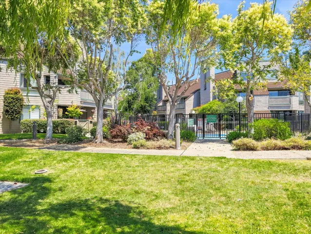 a view of a lake with a building and trees around