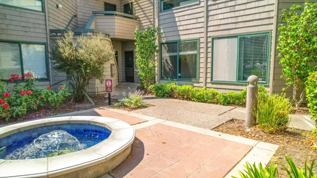 a view of a ocean with boats and trees in the background