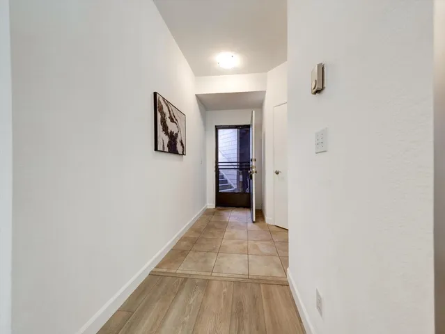 a large kitchen with granite countertop a sink and dishwasher a stove top oven with wooden floor