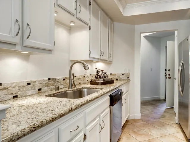 a large white bathroom with a granite countertop sink mirror and bathtub