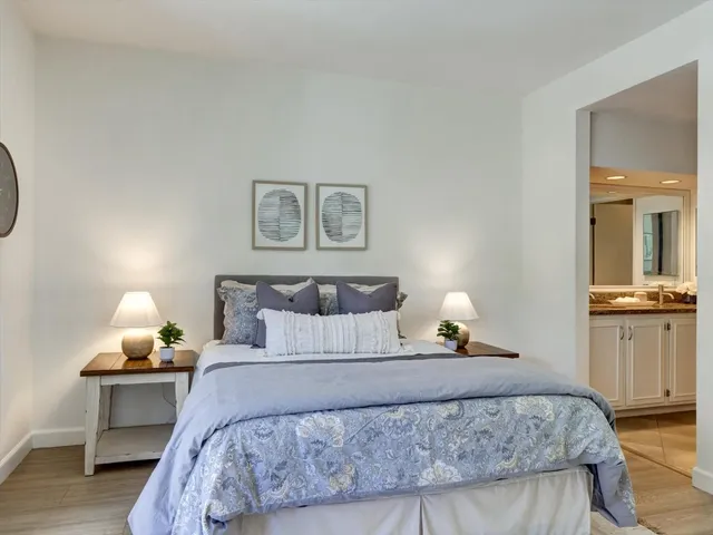 a bedroom with a bed and a table