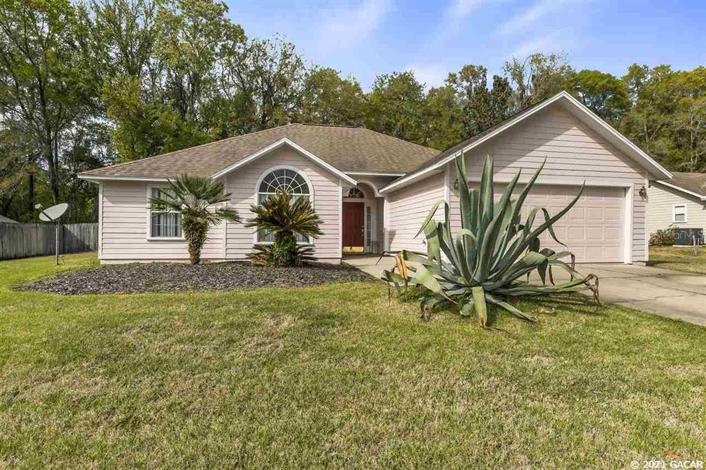 8524 Southwest 57 Lane Gainesville, FL 32608 - Photo 1 of 1 a view of a house with a yard and a garden