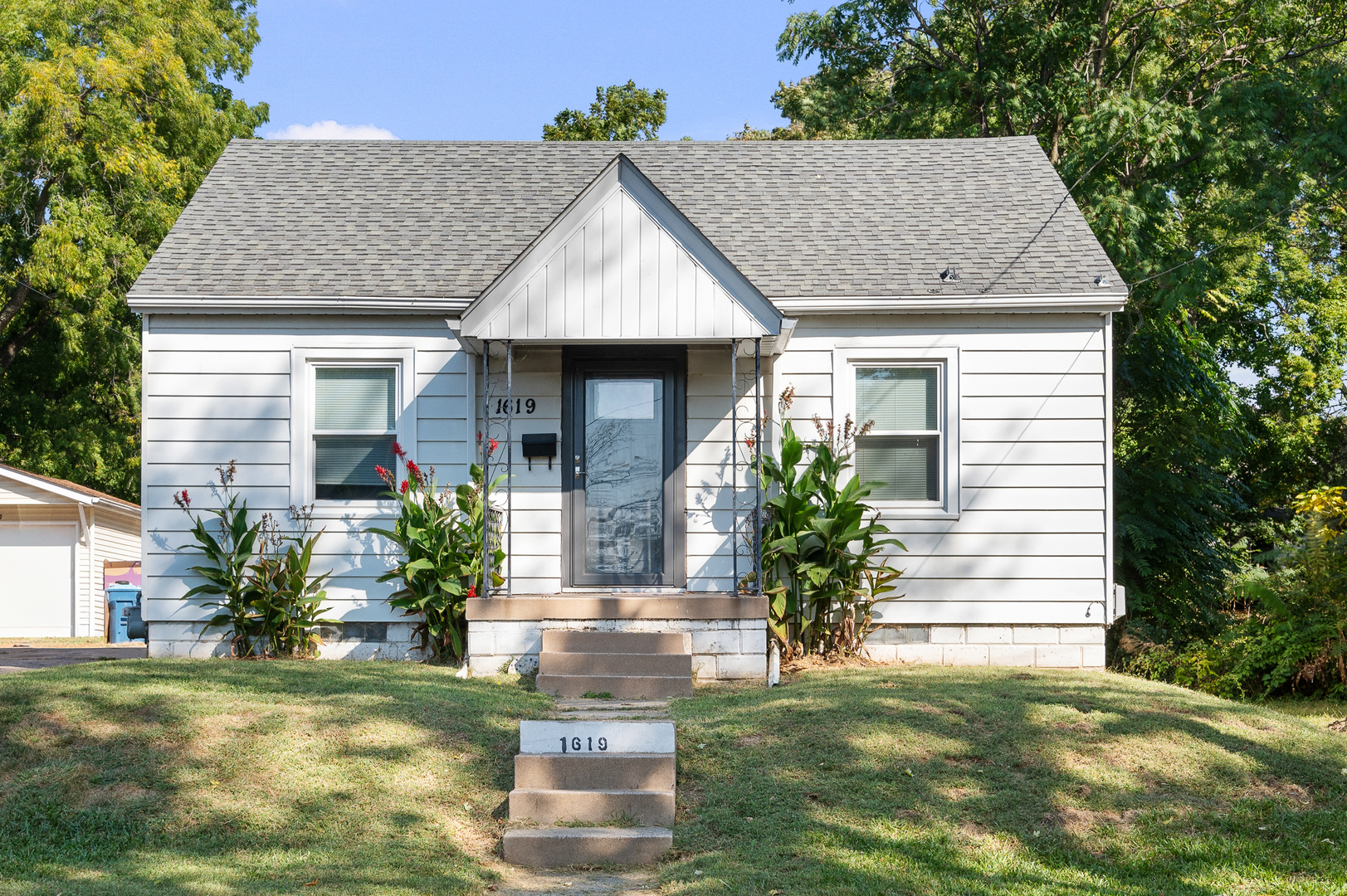 1619 20th Avenue Rock Island, IL 61201 - Photo 1 of 24 a front view of a house with a garden