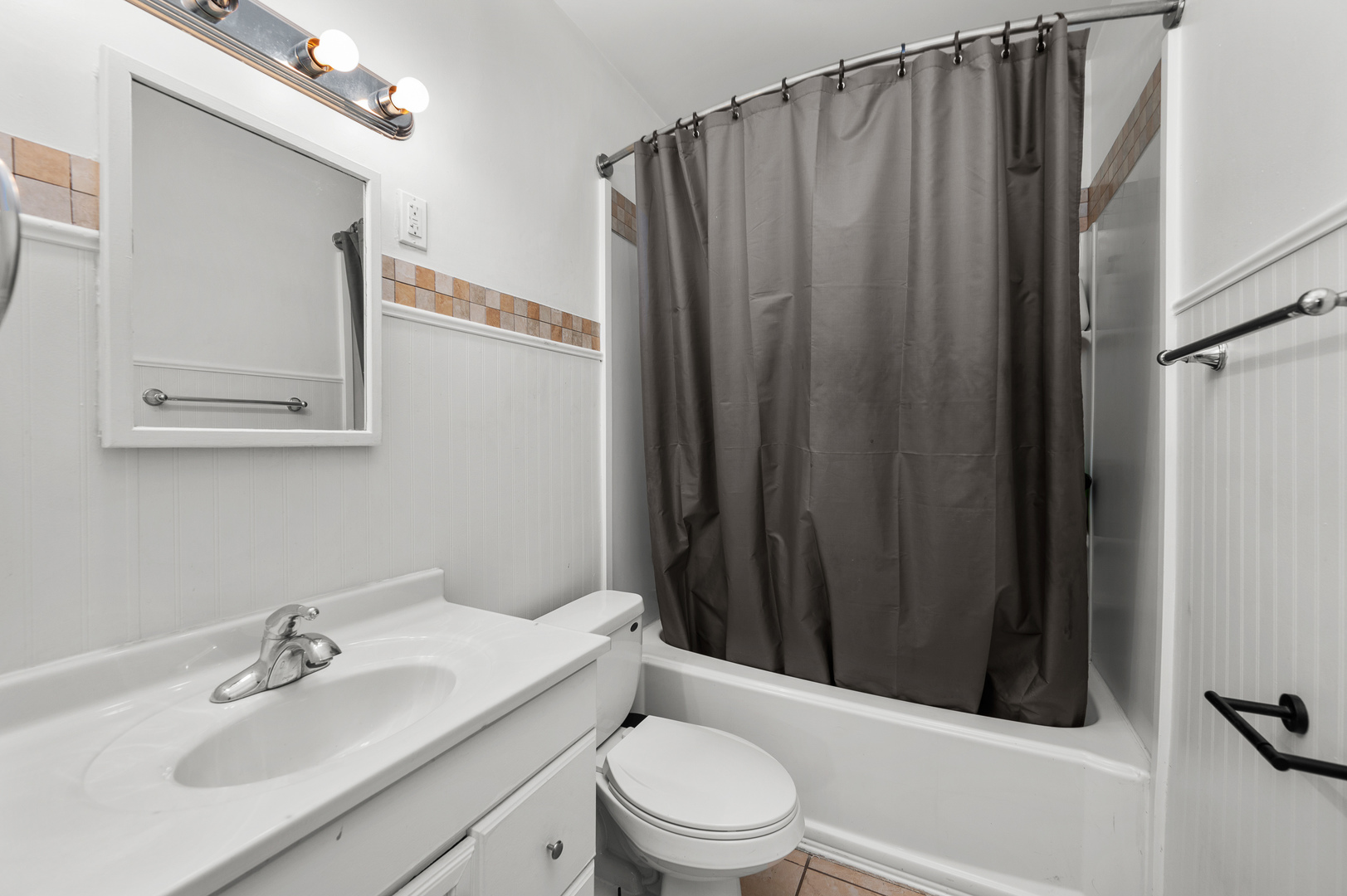 1619 20th Avenue Rock Island, IL 61201 - Photo 8 of 24 a bathroom with a sink a toilet a mirror and shower curtain
