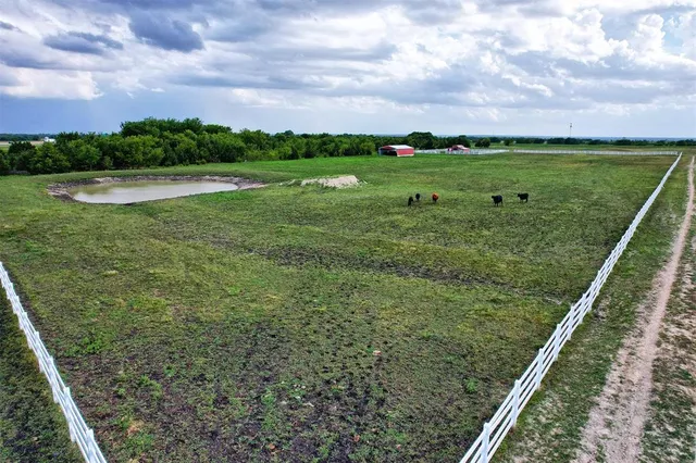 a view of a green field near a lake