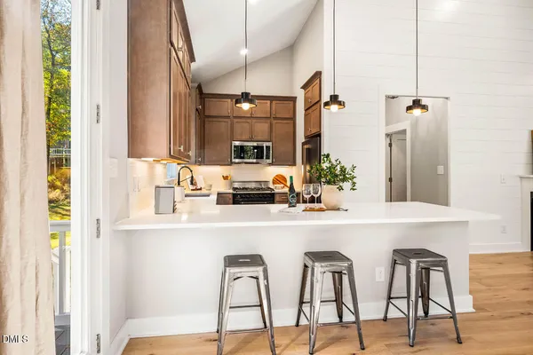a kitchen with kitchen island a sink stove and wooden floor