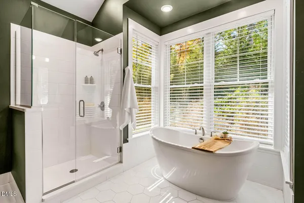 a bathroom with a granite countertop sink mirror and bathtub