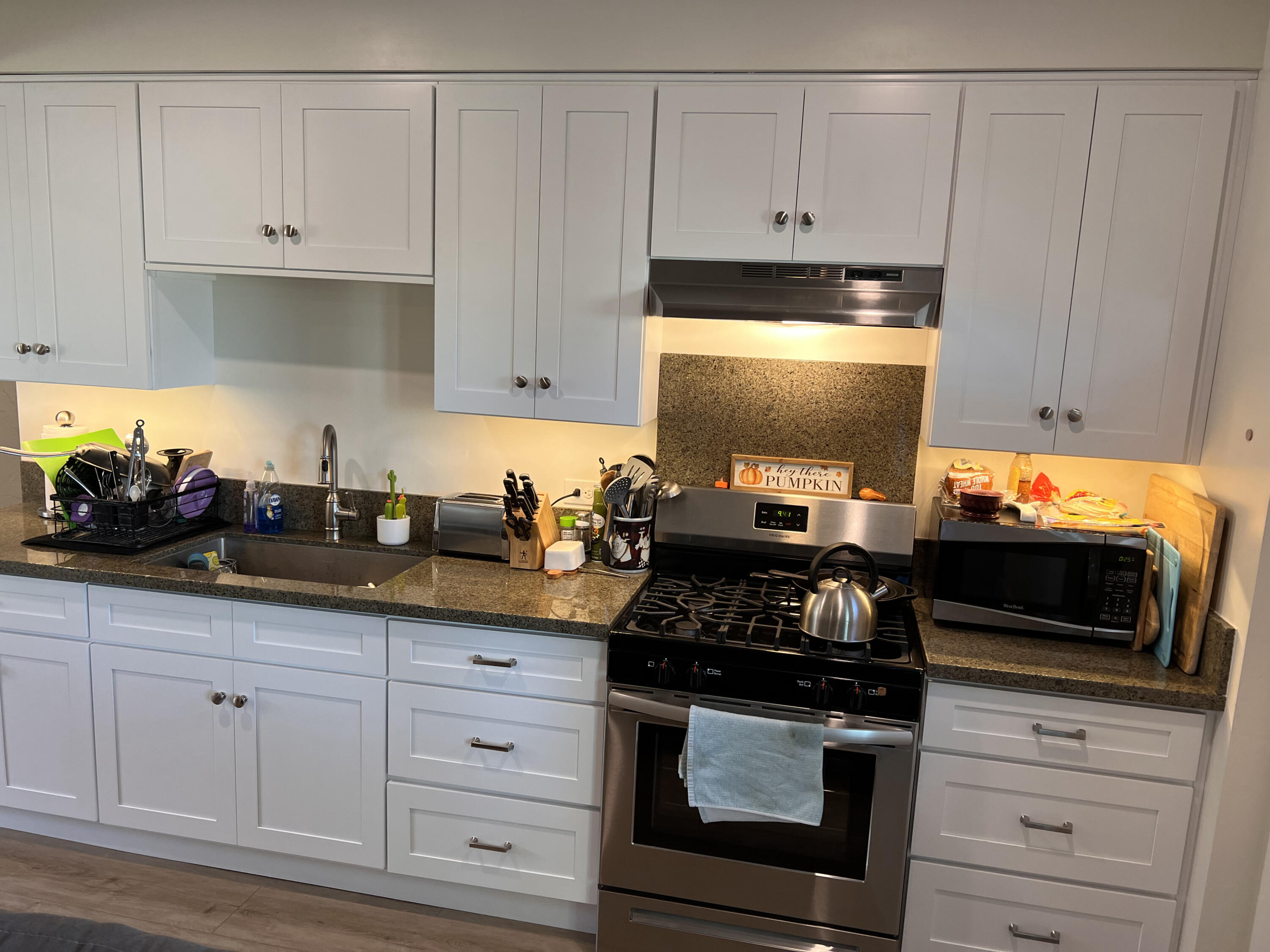 545 Sunbeam Road, Unit C Lompoc, CA 93436 - Photo 5 of 17 a kitchen with granite countertop white cabinets and stainless steel appliances