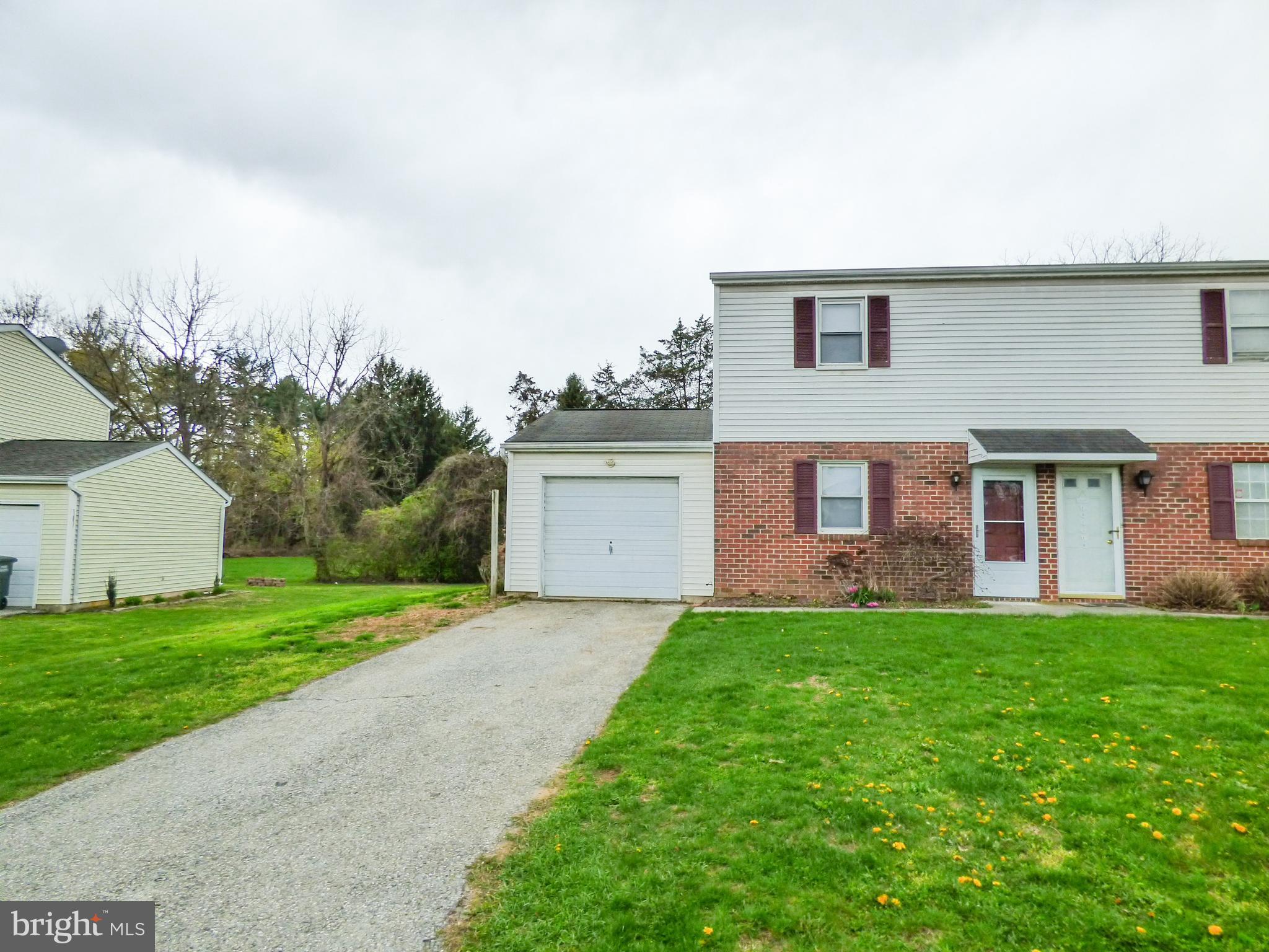 2791 Pineview Drive York, PA 17408 - Photo 2 of 23 a front view of a house with a garden and yard