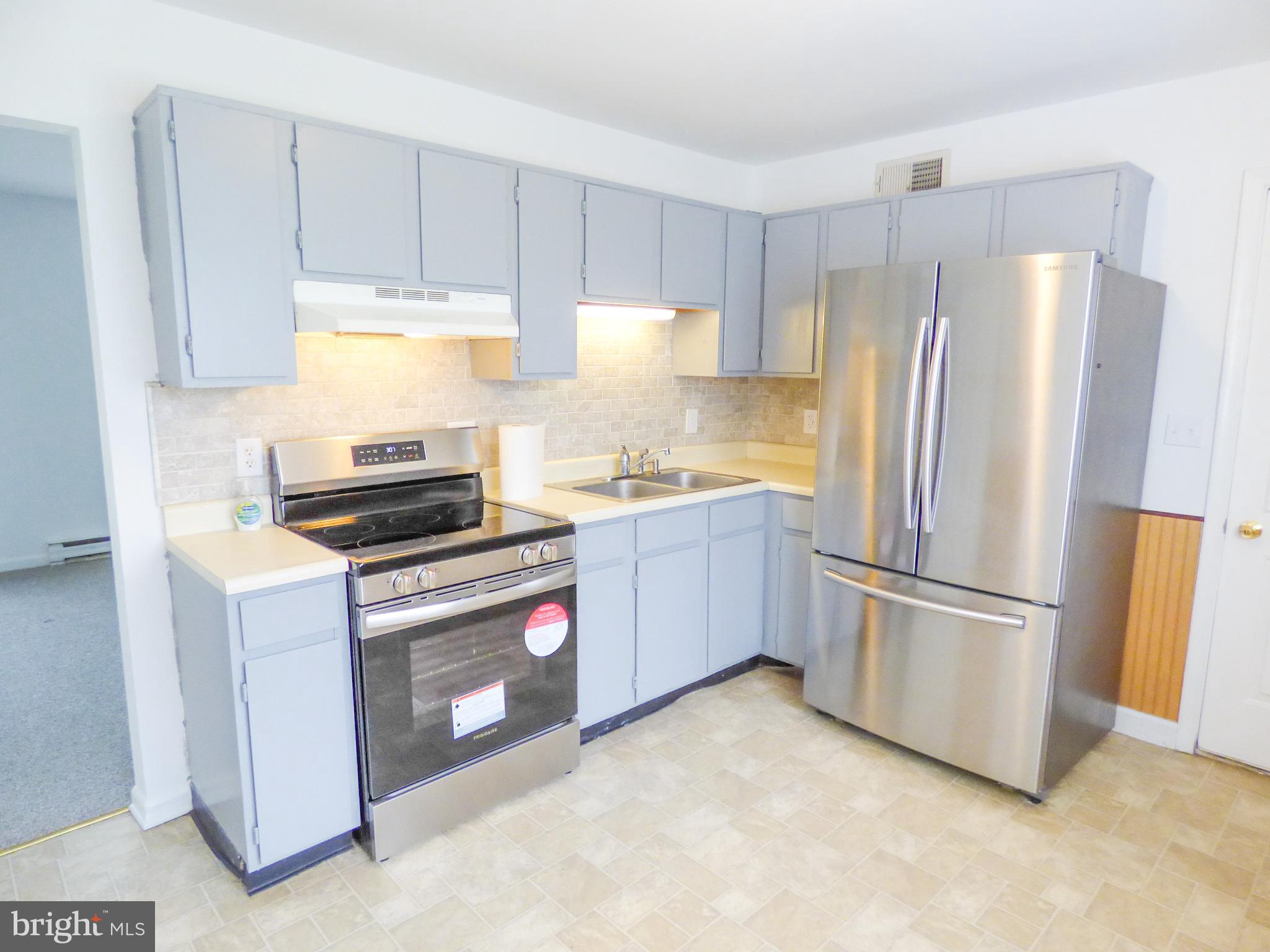 2791 Pineview Drive York, PA 17408 - Photo 10 of 23 a kitchen with stainless steel appliances a refrigerator a stove a sink and a refrigerator