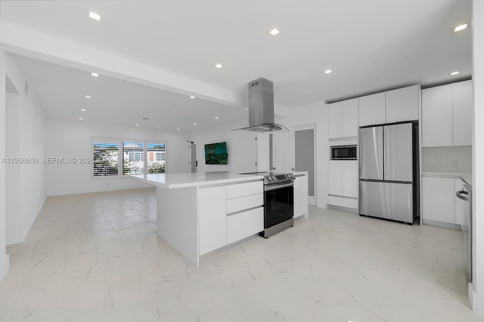 a kitchen with white cabinets and white appliances