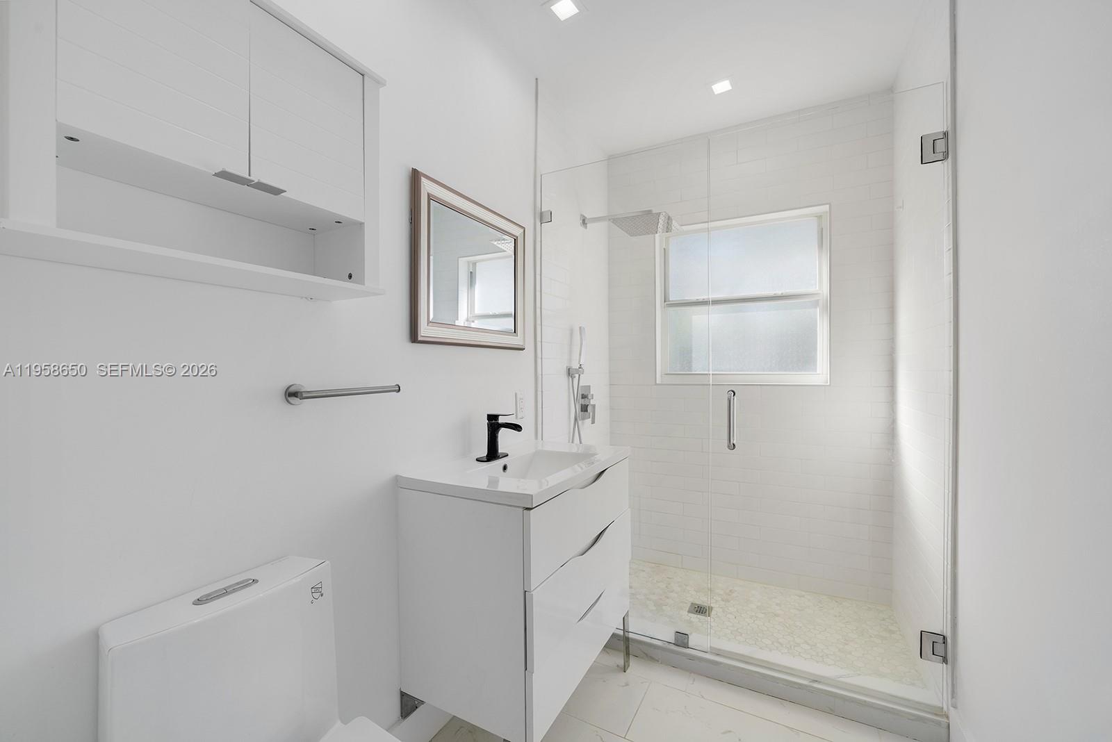 3909 Garden Avenue, Unit 4 Miami Beach, FL 33140 - Photo 15 of 29 a bathroom with a sink a toilet and shower