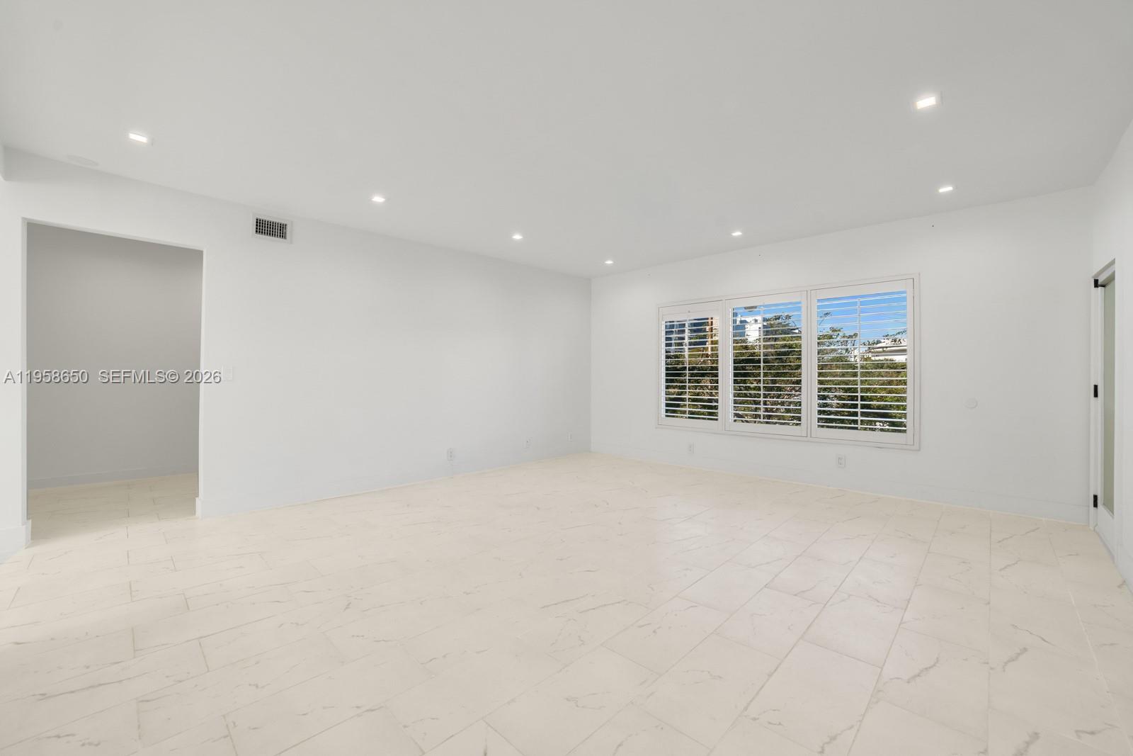 3909 Garden Avenue, Unit 4 Miami Beach, FL 33140 - Photo 19 of 29 an empty room with windows