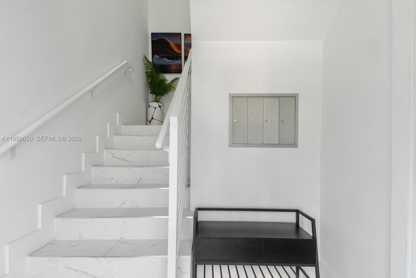 3909 Garden Avenue, Unit 4 Miami Beach, FL 33140 - Photo 22 of 29 a view of staircase with white walls and a window