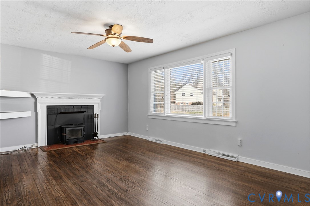 8421 Yolanda Road Henrico, VA 23229 - Photo 22 of 34 a view of an empty room with wooden floor fireplace and a window