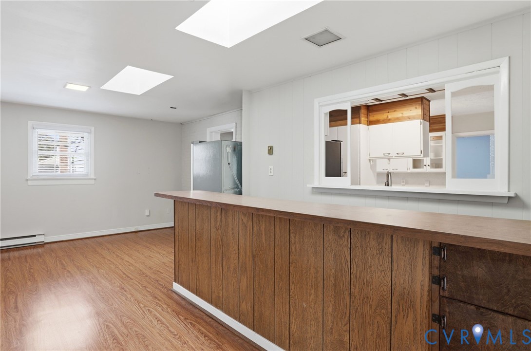 8421 Yolanda Road Henrico, VA 23229 - Photo 26 of 34 a view of an empty room with wooden floor and a window