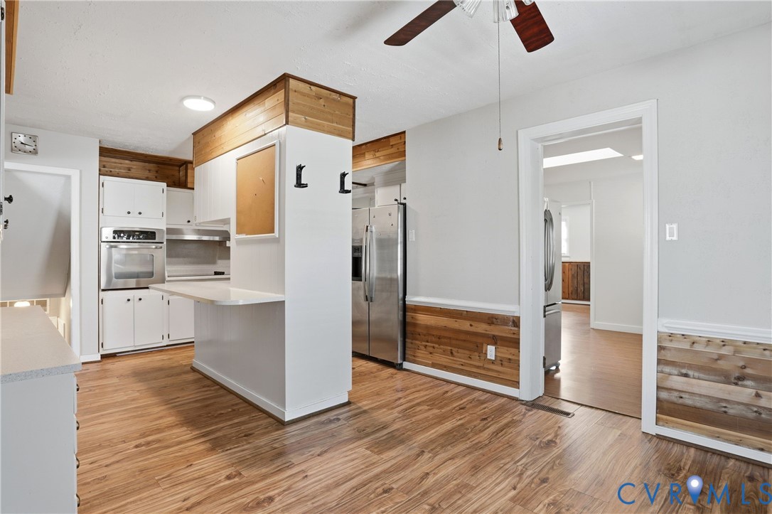 8421 Yolanda Road Henrico, VA 23229 - Photo 27 of 34 a kitchen with white cabinets and stainless steel appliances