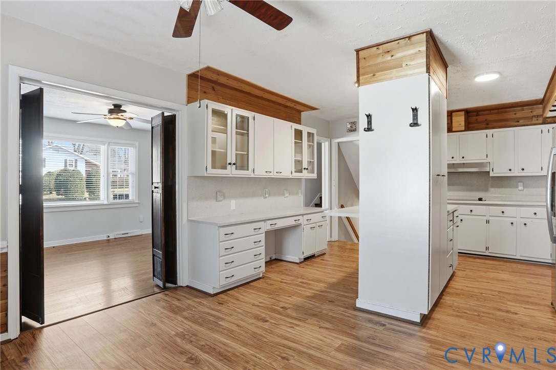 8421 Yolanda Road Henrico, VA 23229 - Photo 28 of 34 a kitchen with white cabinets and wooden floor