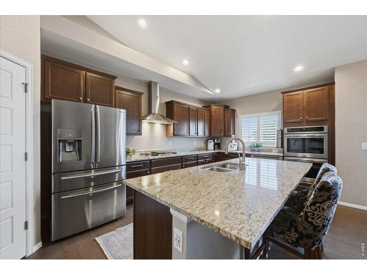 6096 Story Road Timnath, CO 80547 - Photo 11 of 50 a kitchen with stainless steel appliances granite countertop a sink refrigerator and microwave