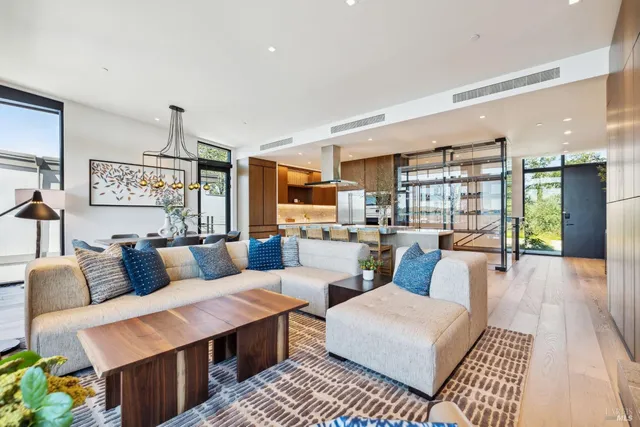 a living room with furniture and a floor to ceiling window