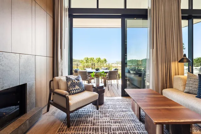 a kitchen with stainless steel appliances kitchen island granite countertop a table chairs and a refrigerator