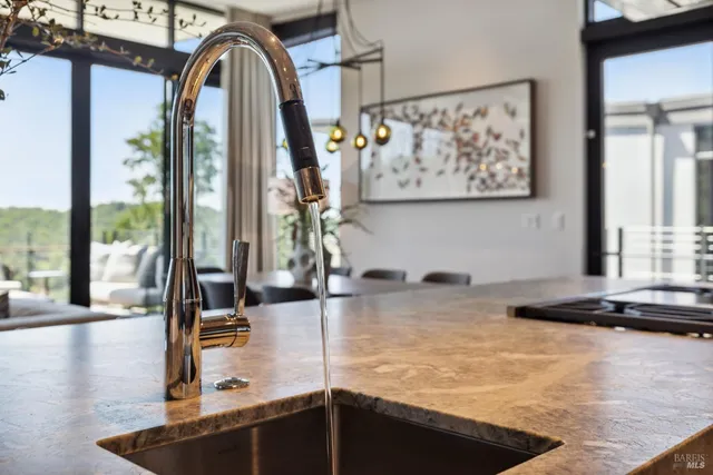 a kitchen with stainless steel appliances granite countertop a sink and wooden cabinets