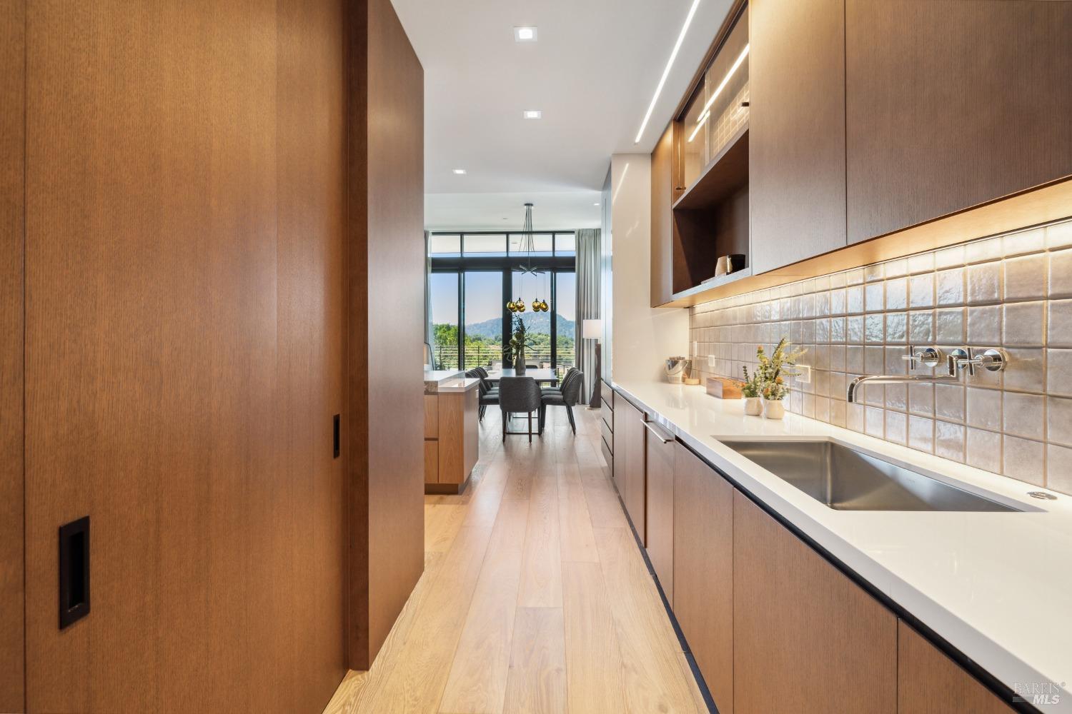 210 East Sumac Court Healdsburg, CA 95448 - Photo 16 of 32 a kitchen with stainless steel appliances granite countertop a sink and wooden cabinets