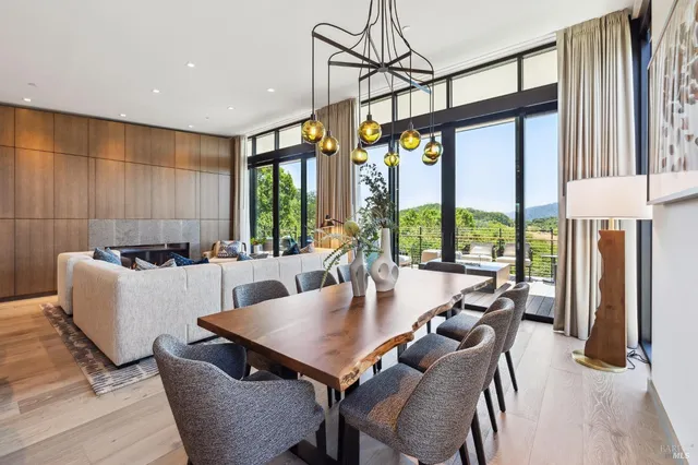 a bedroom with a bed and large windows