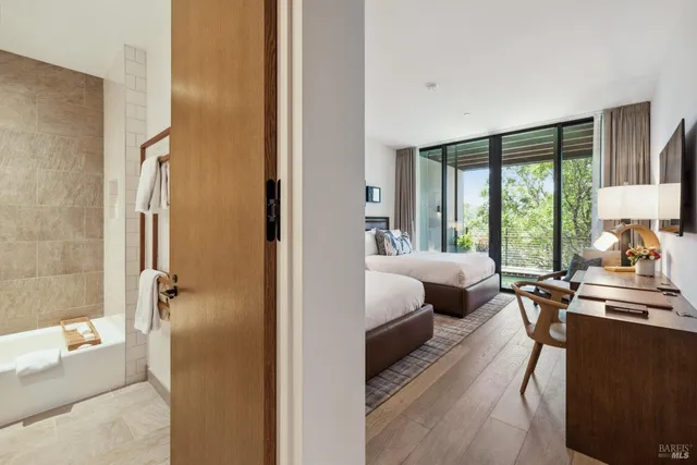 a bedroom with a bed and a large window