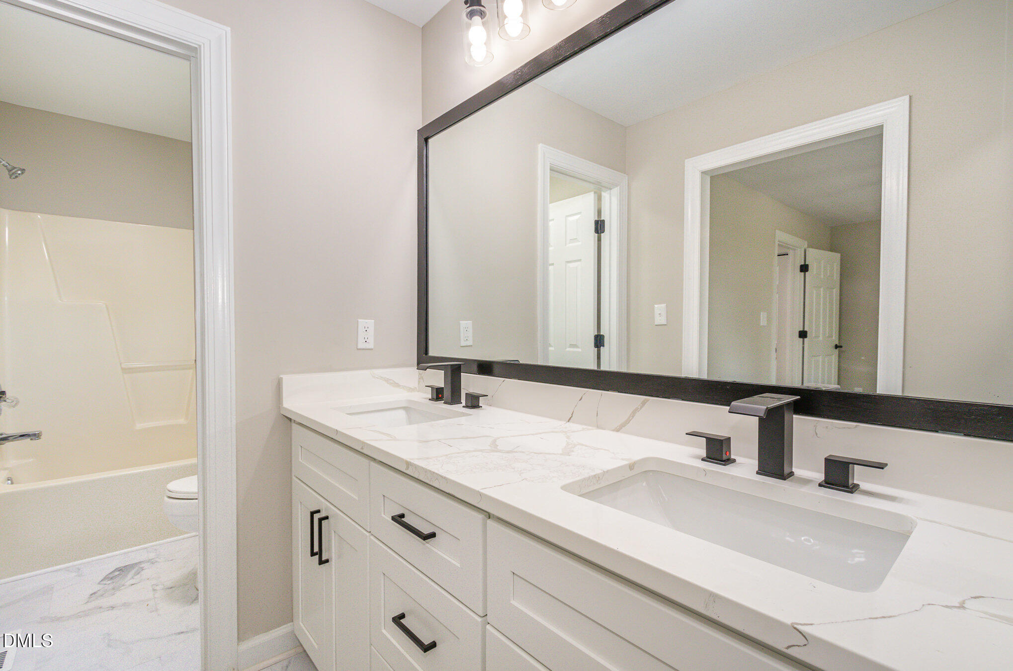 2324 Dahlgreen Road Raleigh, NC 27615 - Photo 13 of 21 a bathroom with a sink and a mirror
