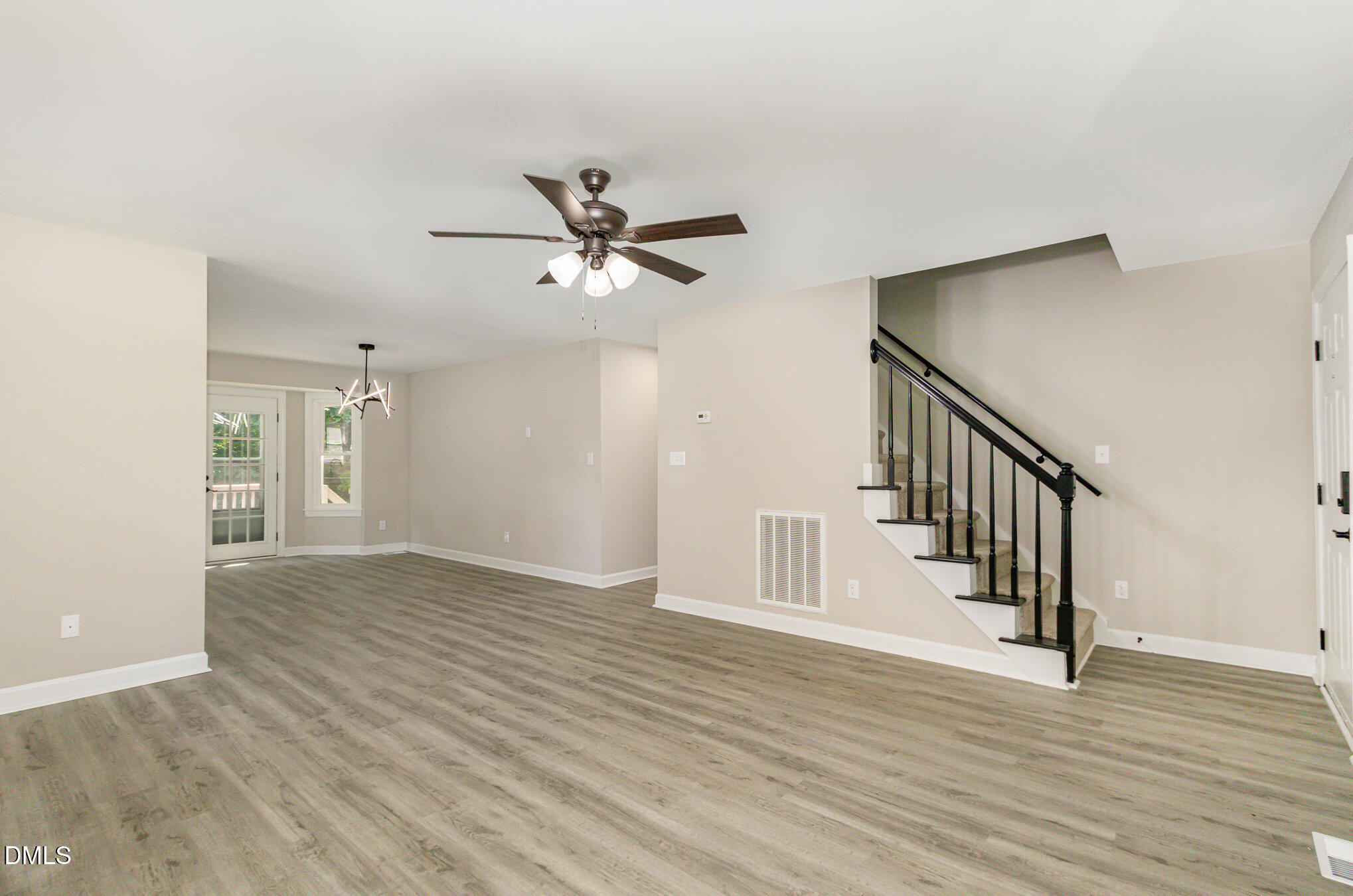 2324 Dahlgreen Road Raleigh, NC 27615 - Photo 4 of 21 a view of an empty room with wooden floor and a ceiling fan