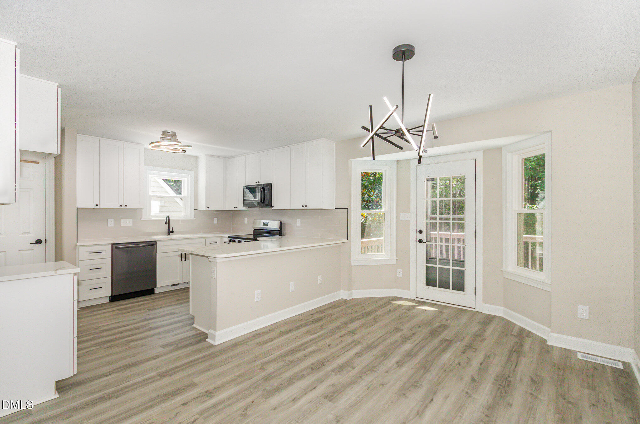 2324 Dahlgreen Road Raleigh, NC 27615 - Photo 5 of 21 a kitchen with granite countertop a stove cabinets and wooden floor