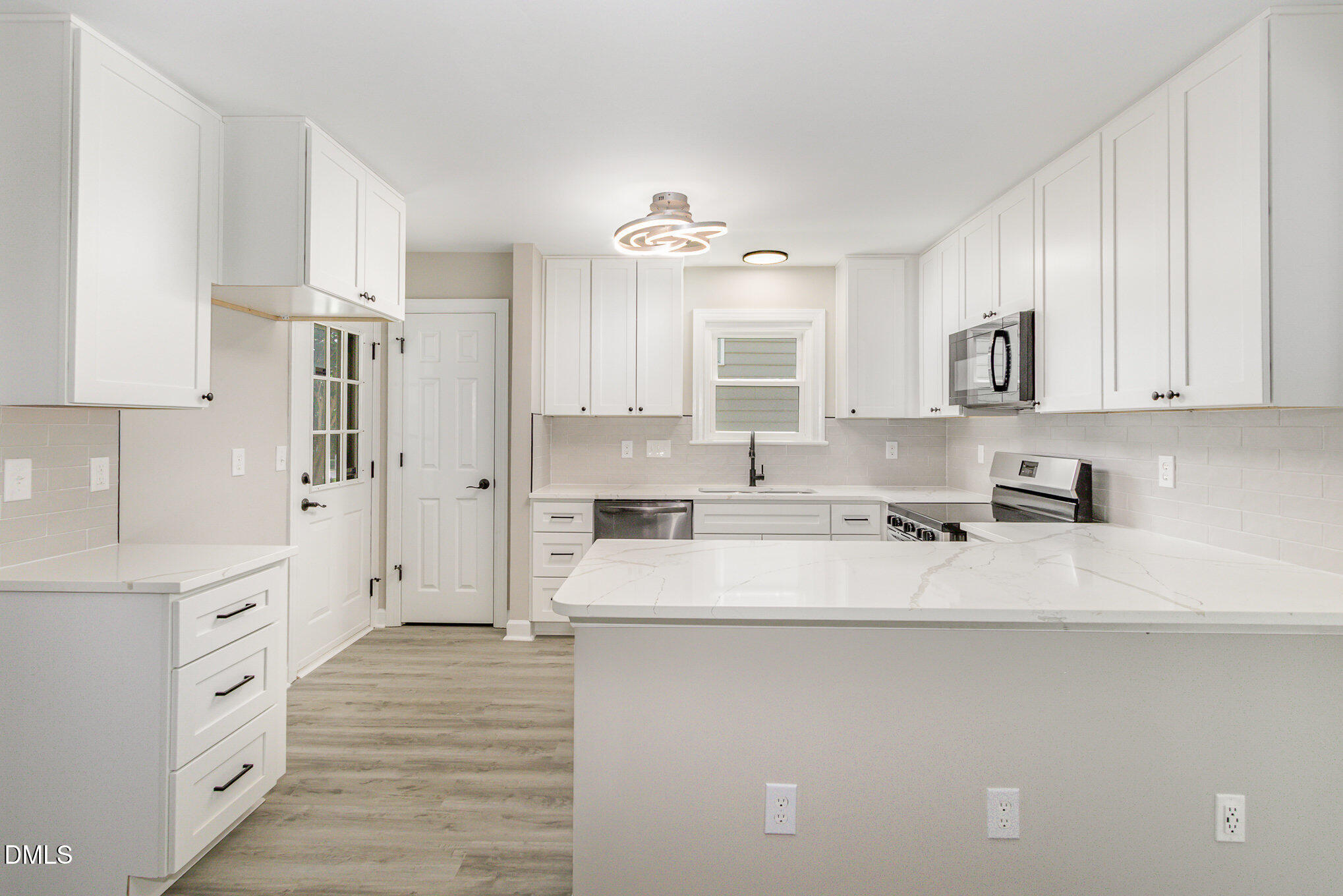 2324 Dahlgreen Road Raleigh, NC 27615 - Photo 7 of 21 a kitchen with stainless steel appliances granite countertop a sink stove and refrigerator