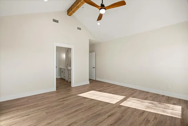 a spacious bathroom with double sink and a mirror