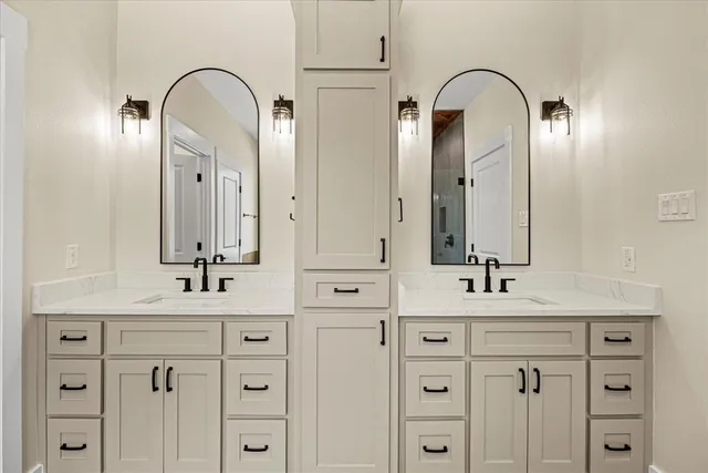 a bathroom with a double vanity sink and mirror
