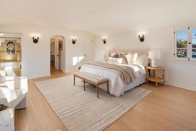 a spacious bedroom with a bed and a couch