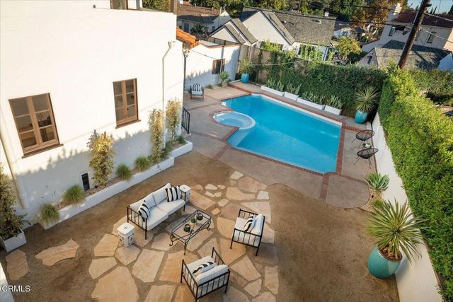 an aerial view of a house with a yard and parking