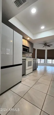 a kitchen with stainless steel appliances a refrigerator sink and cabinets