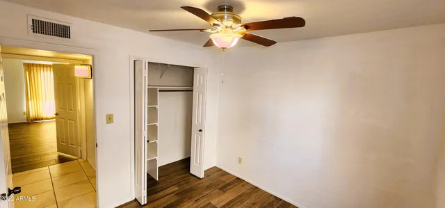 a view of empty room with wooden floor